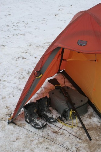 Not your typical tent vestibule. Shoes, camerabag and shotgun. Same on each side.