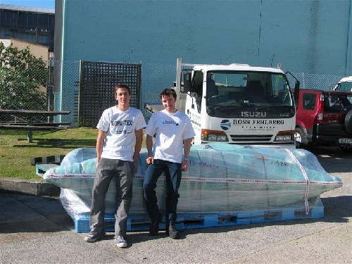 All done! Chris and Clark infront of wrapped up PACs delivered to shipping company!