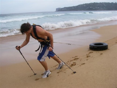 Clark dragging tyre along palm beach